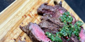 Butter seared New Zealand ribeye steak topped with Chimichurri sauce Butter seared New Zealand ribeye steak topped with Chimichurri sauce